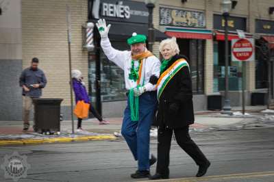 An Ancient Order of Hibernians pair passing out bead necklaces