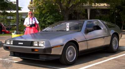 DMM's Michele standing by a Delorean